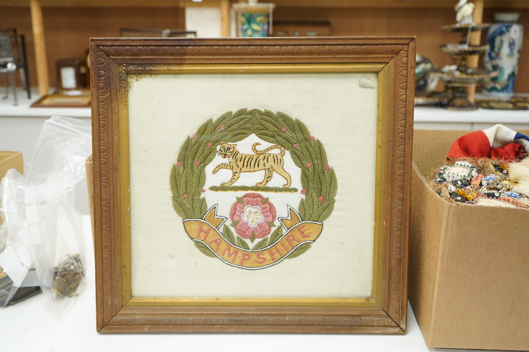 A collection of militaria, etc. including; a Gordon Highlander’s kilt and sporran, three early 20th century Union Flags, a Victorian beaded ‘sweetheart’s’ cushion, two empty First World War Princess Mary Christmas tins,